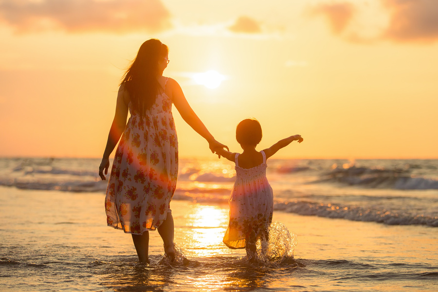 Silhouette of Mother and Daughter by the Beach